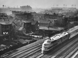 Train Moving Past Trackside Tenement Slums of Chicago