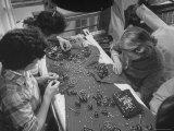Workers with Piles of Gems Putting Pattern on a Heavily Embroidered Gown