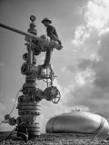 Workman Standing on Machinery at Natural Gas Plant
