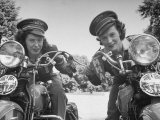 Woman and Her Daughter Sharing Interest in Motorcycle Racing