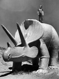 Young Boy Standing Atop Large Statue of Dinosaur in "Dinosaur Park" Tourist Attraction