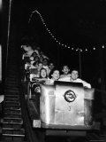 Teenagers in Rollercoaster at Night