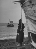Woman Watching a Man Fishing on a Boat