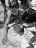 Settlement House Children Burying Boy under Sand at the Beach