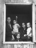 Portrait of a Family of Indonesian Refugees Framed by a Window of the Barracks Home