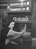 Young Woman Wearing a Winter Coat and Hat  Reading Beneath 