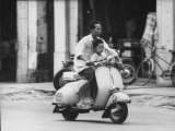 Man with His Son on Scooter