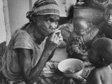 Mother and Starving Children Eating
