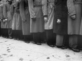 Men in Ill Fitting Coats Lining Up to Enlist in Well Dressed Guards