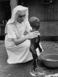 Sister Therese is Bathing a Child Suffering from Protein Deficiency Disease