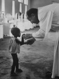 Roman Catholic Priest Chatting with Healing Child