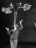 Robert Dotzauer Balancing Lawn Mowers Weighing a Total of 145 lbs on His Chin
