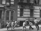 Young Boys with Sticks  Running Around While Playing a Street Game in Spanish Harlem