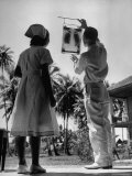 Missionary Edwin B McDaniel Looking at X-Ray Outside Hospital