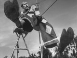 Student Circus Performer Johnnie Fortune in Costume Doing Comic Act While Hanging to Tightwire