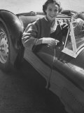 Well Dressed Woman Behind the Wheel of a Foreign Made Roadster