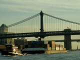 Tugboat Pulling a Barge on the East River Under the Manhattan Bridge