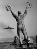 Shot of a Man Using Hand Lights to Signal an Incoming Aircraft Towards the Carrier's Landing