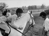 Young Girl Riding a Welsh Pony in a Competition