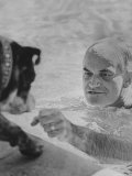 Arizona Senator Barry Goldwater Playing with His Dog While Swimming in His Pool at Home