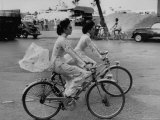 Women Riding Bicycles in Saigon