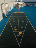Woman Playing Shuffleboard Game on a Cruise Ship