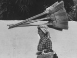 Street Scene with Woman Carrying Brooms on Her Head