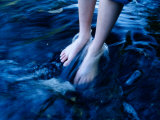 A Close View of Feet in River Water