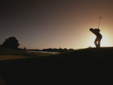 A Man Plays a Game of Golf at Twilight