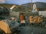 An Aymara Woman and Cat on a Path in an Atacama Desert Village