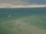 Shrimp Boat Hovers Above Rippled Sand in Wattenmeer National Park