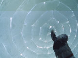 A Man Places the Last Block in an Igloo He is Constructing