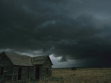 Heavy Dark Clouds Foretell a Possible Tornado Near an Old Homestead