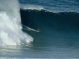 A Surfer Rides a Powerful Wave off the North Shore of Maui Island