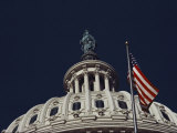 An American Flag and the Statue of Freedom Atop the Capitol Dome