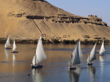Feluccas on the Nile Sail Past the Tombs of Qubbat Al Hawa at Aswan