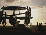 Military Personnel Stand Next to an Awacs Surveillance Plane