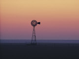 A Windmill Breaks the Flat Horizon of the Texas Panhandle at Dawn