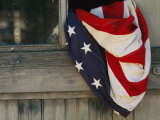 An American Flag Draped Through an Open Barn Window
