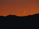 A Crescent Moon Sets over Mountains Rimming the Western Edge of Lake Tahoe