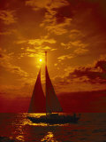 A Passing Sailboat is Silhouetted against a Brilliant Orange Sunset Near Bermuda