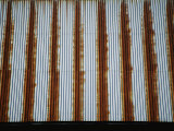 Lines of Rust Make a Bold Pattern Across an Old Corrugated Barn Roof