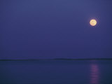 Purple Sky and Moon over a Body of Water