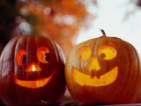 A Cheerful Pair of Jack-O-Lanterns against a Background of Fall Foliage