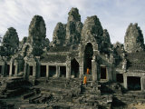 Monks in Orange Robes Stand on the Step Outside a Buddhist Temple