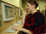 A Russian Woman Uses a Mobile Phone and Computer at an Internet Cafe