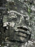 A Serene Likeness of Buddha Sculpted of Stone Peers from a Temple Wall