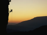A Man Rappels Down a Cliff