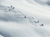 Six Skiers Make Their Way Down a Snow-Covered Hill