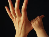 A Babys Tiny Fist Clings to Her Mothers Thumb